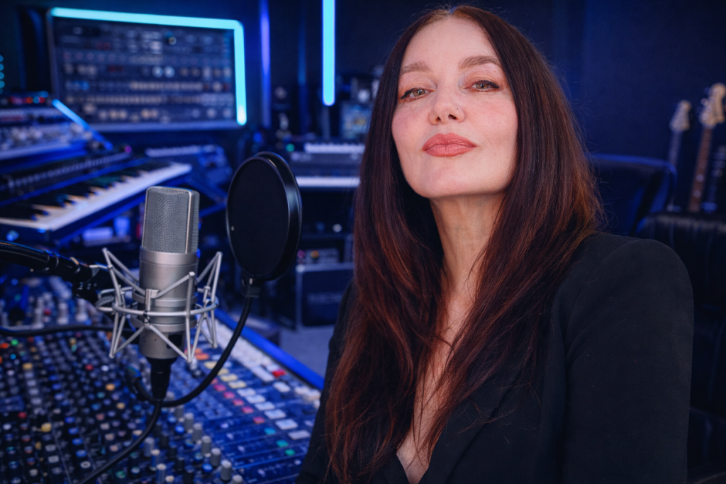 Woman in music studio with microphone.